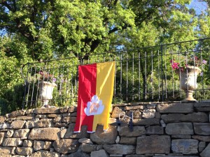The flag of S Ubaldo the patron saint of Gubbio hanging in the gardens at Bellaugello Gay Guest House, Umbria, Italy