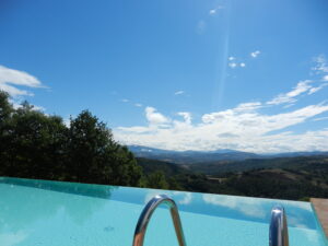 Over the infinity pool at Bellaugello Gay Guest House in Umbria, looking towards the Monte Sibylline national park